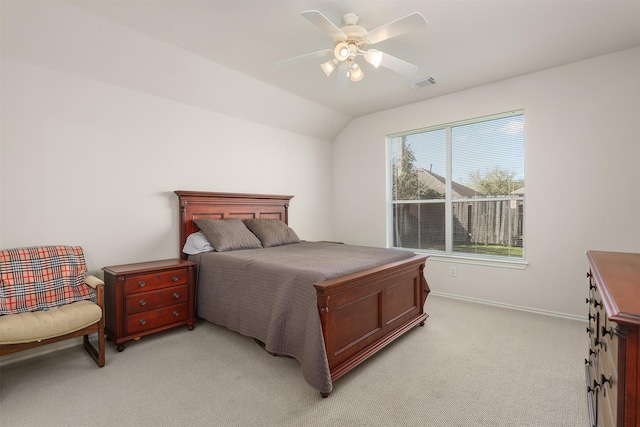 bedroom with visible vents, baseboards, light colored carpet, ceiling fan, and vaulted ceiling