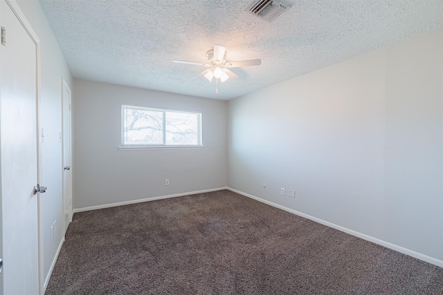 empty room with visible vents, baseboards, carpet, and ceiling fan