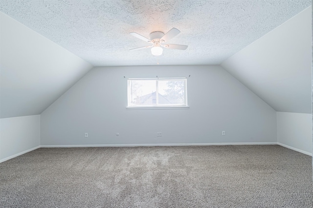 bonus room with lofted ceiling, a textured ceiling, and carpet