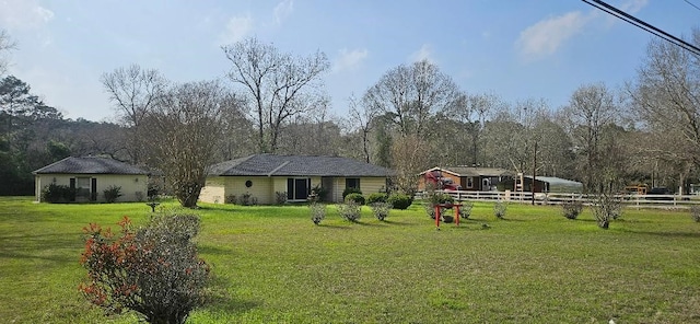 view of front of house with a front lawn and fence