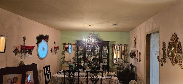 dining space featuring a chandelier and visible vents