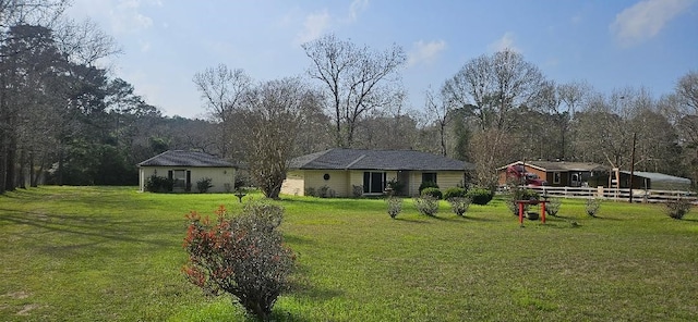 view of front of home with fence and a front yard