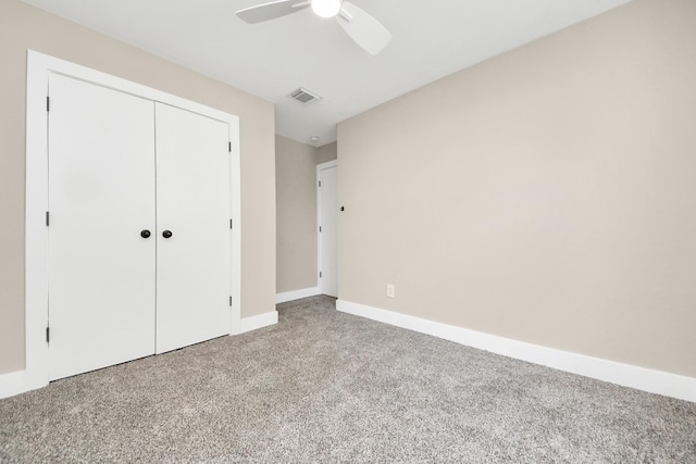 unfurnished bedroom with carpet floors, a ceiling fan, visible vents, baseboards, and a closet