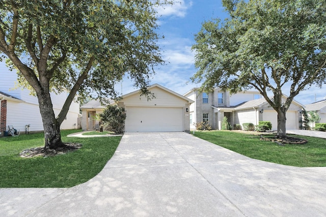 view of front facade featuring a garage, concrete driveway, and a front yard