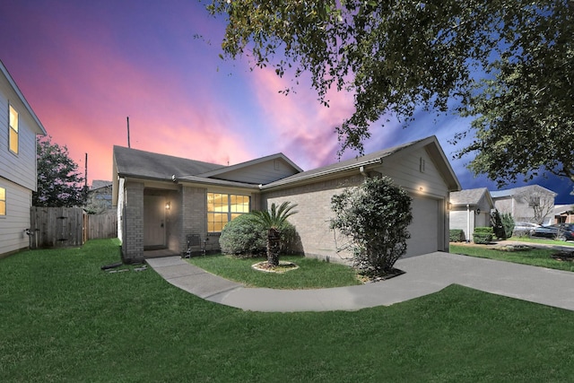 ranch-style house featuring an attached garage, driveway, a lawn, and brick siding