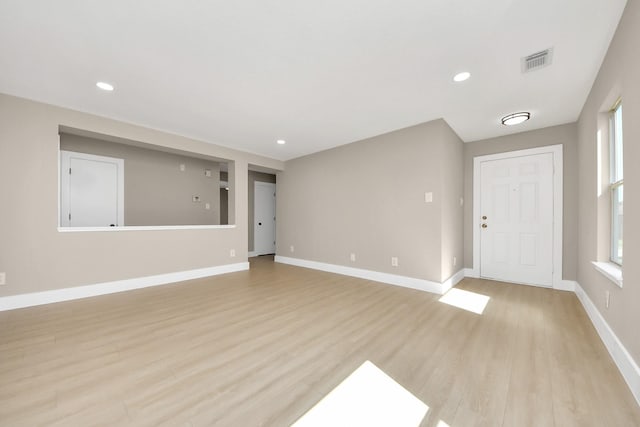 interior space featuring light wood-style floors, recessed lighting, visible vents, and baseboards