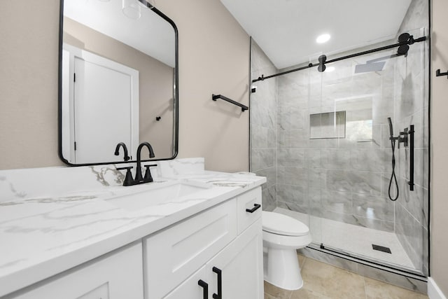 bathroom featuring toilet, a shower stall, tile patterned flooring, and vanity