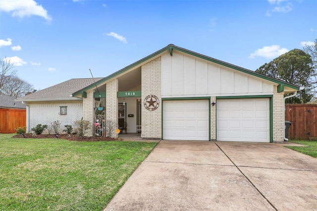 mid-century inspired home featuring brick siding, a front yard, and fence