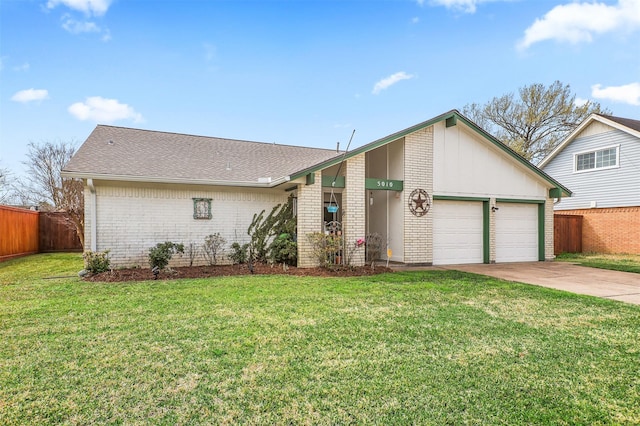 mid-century inspired home with a garage, brick siding, concrete driveway, fence, and a front yard