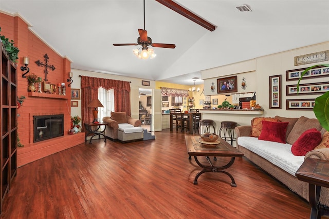 living room featuring wood finished floors, visible vents, a ceiling fan, a brick fireplace, and beamed ceiling