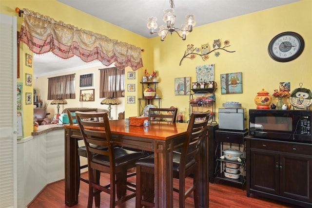 dining area featuring a notable chandelier, crown molding, and dark wood-type flooring