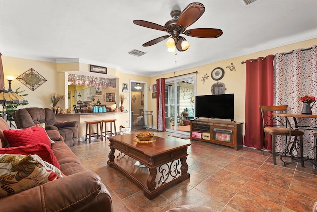 living area with ceiling fan, visible vents, and ornamental molding