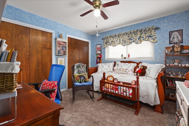 interior space featuring a ceiling fan, carpet, two closets, and wallpapered walls