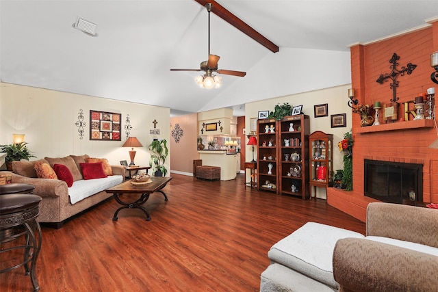 living room featuring vaulted ceiling with beams, visible vents, a fireplace, and wood finished floors