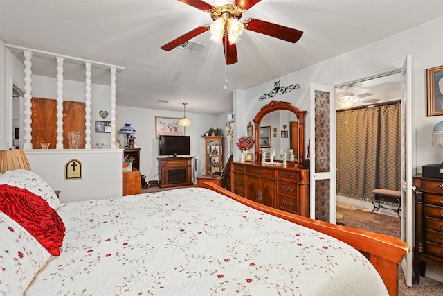 bedroom featuring carpet, visible vents, a fireplace, and ceiling fan