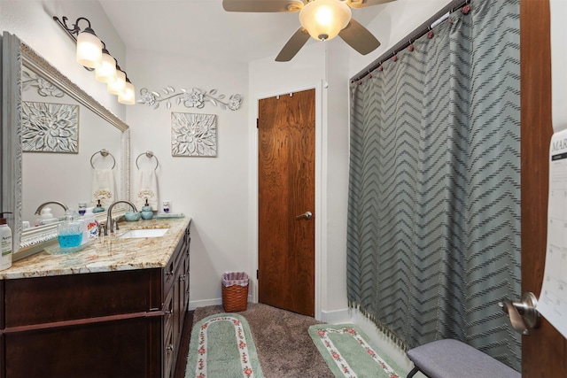 bathroom featuring a ceiling fan, vanity, and baseboards