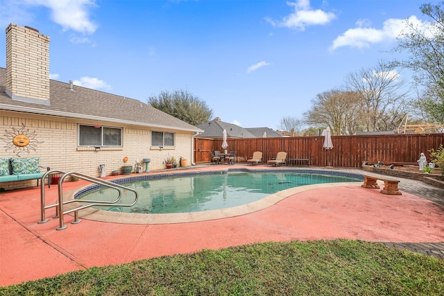 view of swimming pool featuring a fenced in pool, a fenced backyard, and a patio