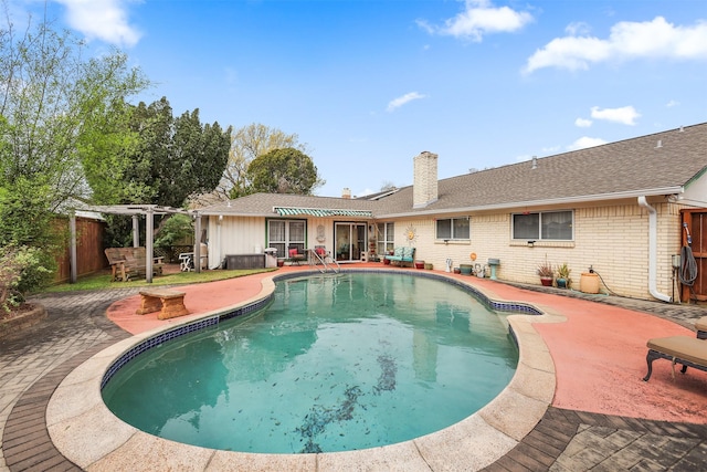 pool with a patio area, fence, and a pergola