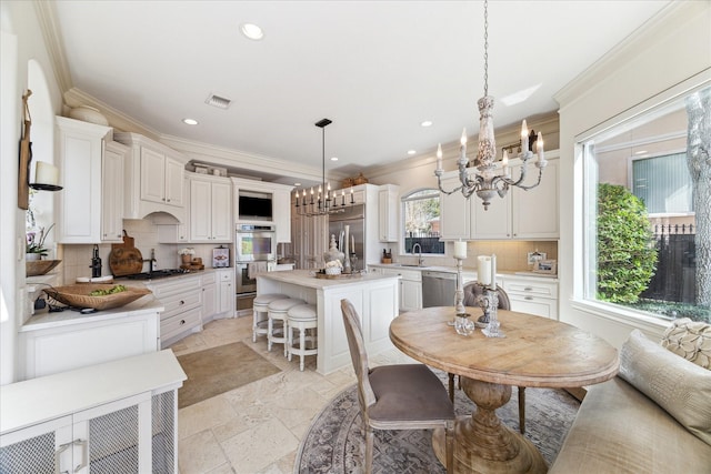 dining room featuring visible vents, stone tile flooring, recessed lighting, crown molding, and a chandelier