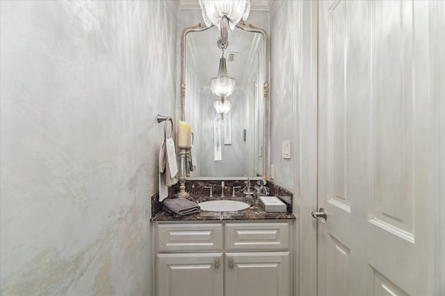 bathroom featuring vanity and a notable chandelier