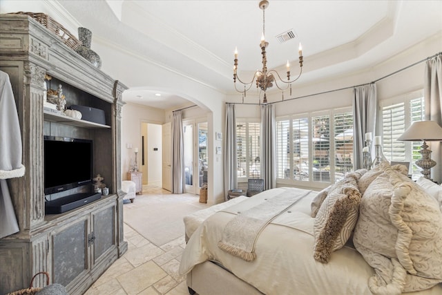 bedroom featuring a tray ceiling, arched walkways, visible vents, and stone tile flooring