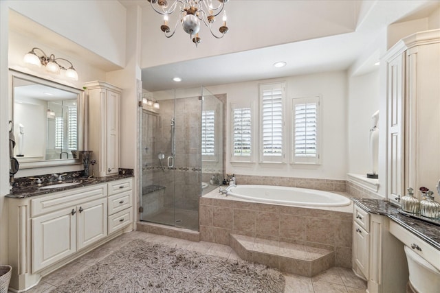 full bathroom featuring vanity, a garden tub, a healthy amount of sunlight, and a stall shower