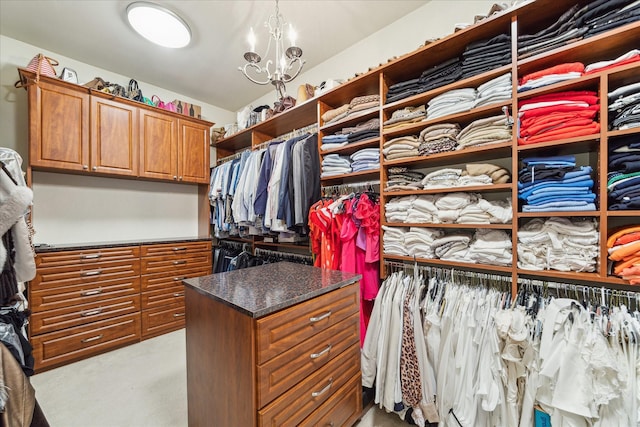 spacious closet featuring a notable chandelier