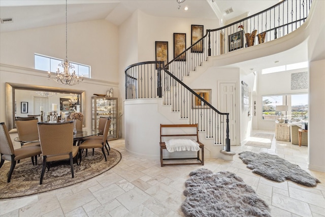 dining area with a notable chandelier, stairway, stone tile floors, and visible vents