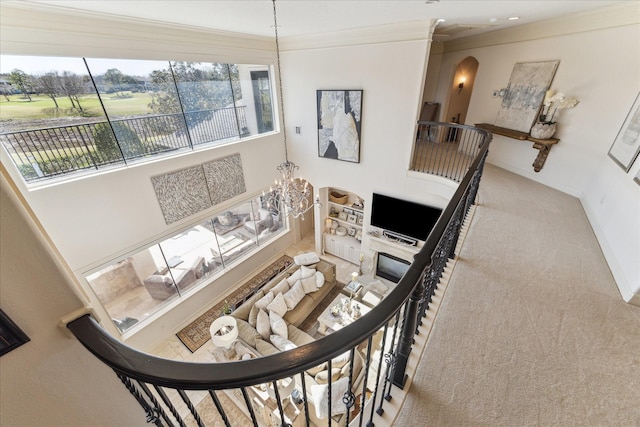 stairs featuring ornamental molding, arched walkways, an inviting chandelier, carpet flooring, and baseboards