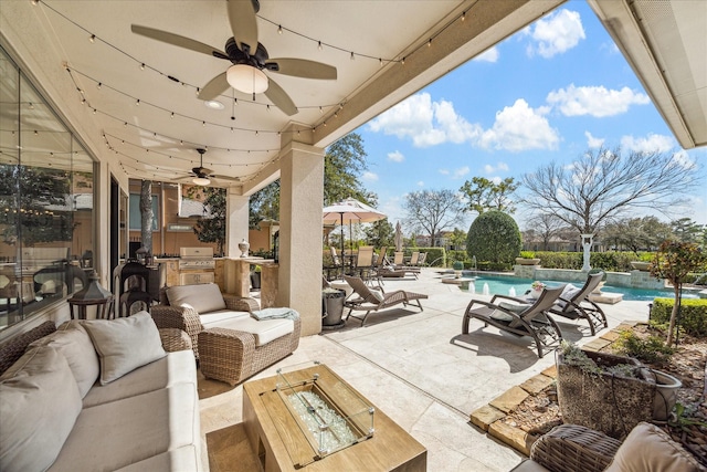 view of patio featuring a ceiling fan, an outdoor kitchen, an outdoor pool, grilling area, and outdoor lounge area