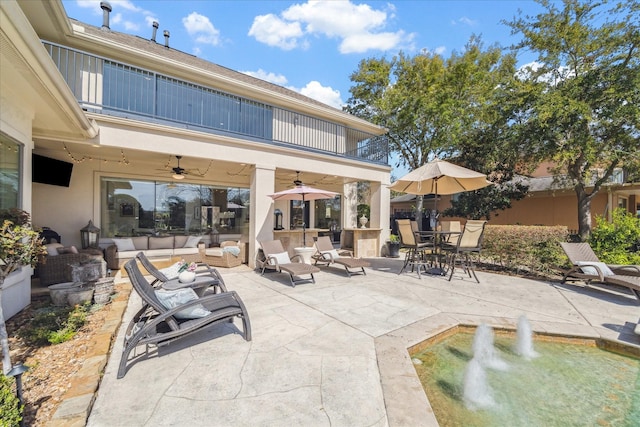 view of patio featuring outdoor dining space, ceiling fan, an outdoor hangout area, and a balcony