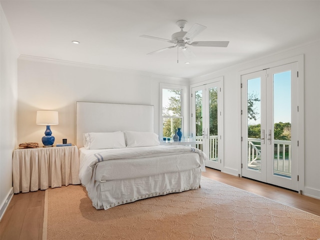 bedroom featuring access to exterior, multiple windows, and crown molding