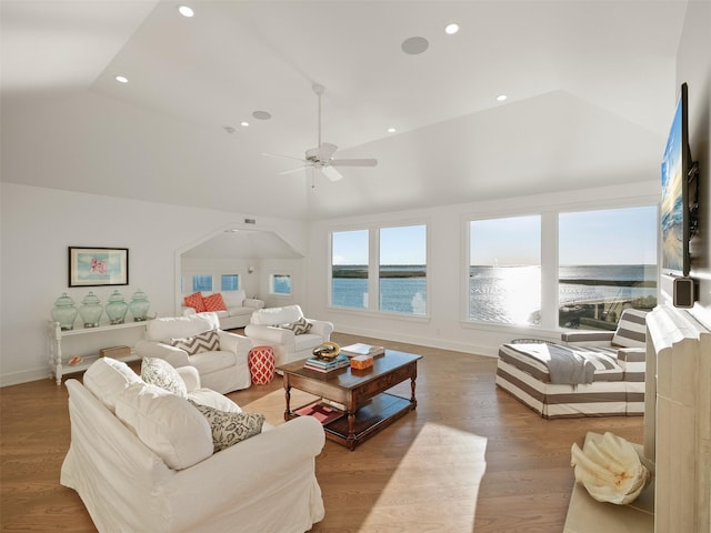 living room featuring baseboards, vaulted ceiling, wood finished floors, and recessed lighting