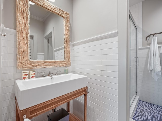 full bathroom featuring a stall shower, crown molding, tile walls, and tile patterned floors