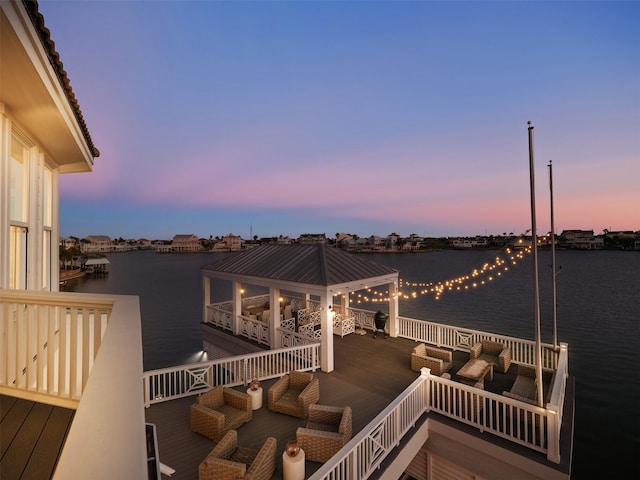 view of dock with an outdoor hangout area and a water view