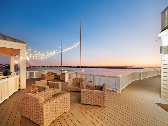 wooden terrace featuring outdoor lounge area and a water view