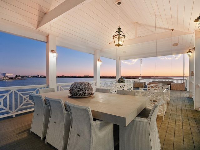 interior space with outdoor dining space and a water view