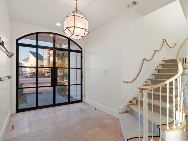 entryway with stairway, baseboards, visible vents, and recessed lighting