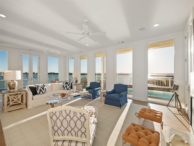 sunroom with a ceiling fan and french doors