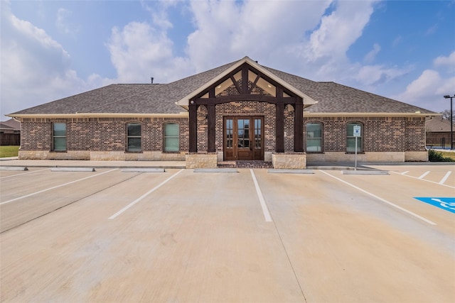 view of building exterior with uncovered parking