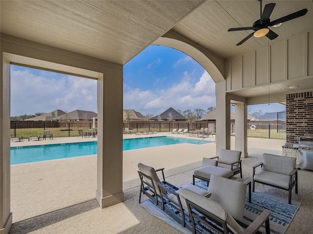 pool featuring a fenced backyard, area for grilling, a ceiling fan, and a patio