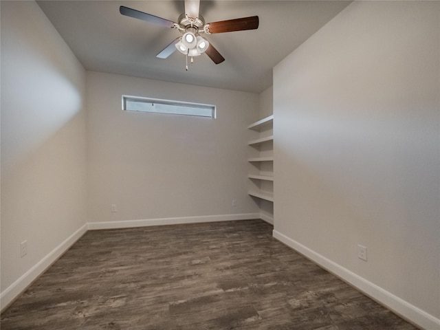 spare room featuring dark wood finished floors, baseboards, and ceiling fan