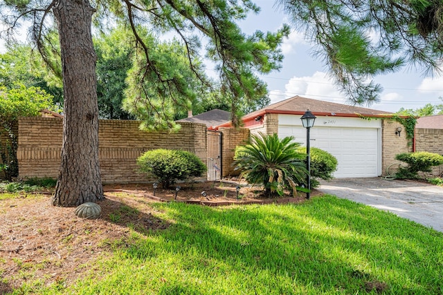 view of front of home featuring a garage, brick siding, fence, driveway, and a gate