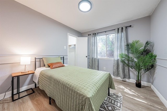 bedroom featuring baseboards and wood finished floors