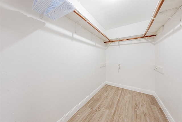 walk in closet featuring light wood-style flooring