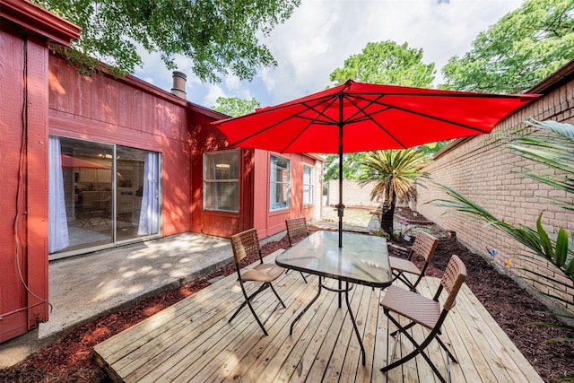 wooden terrace featuring fence and outdoor dining space