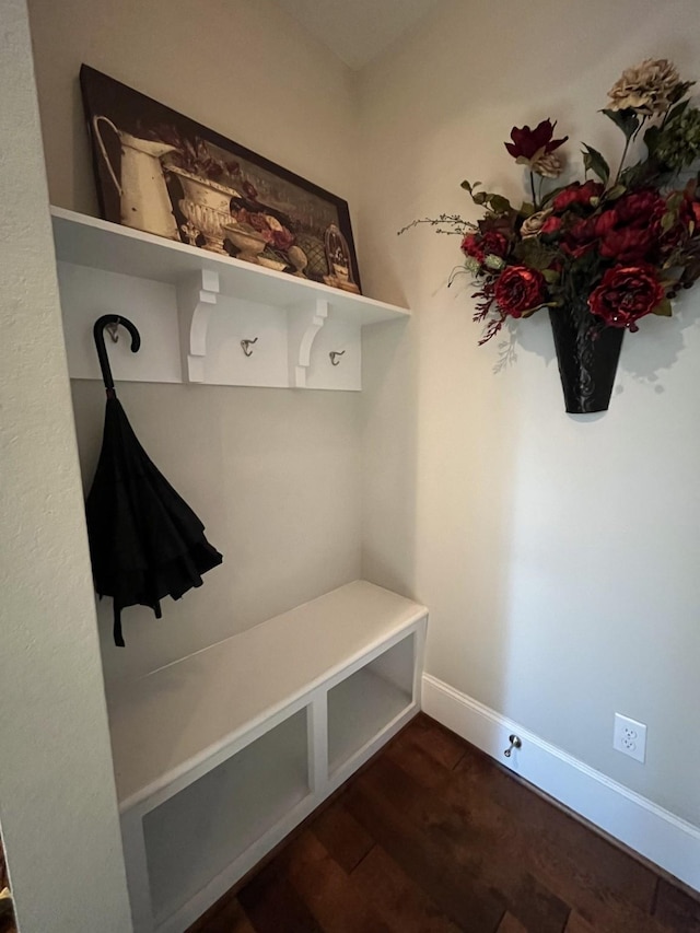 mudroom featuring dark wood finished floors and baseboards