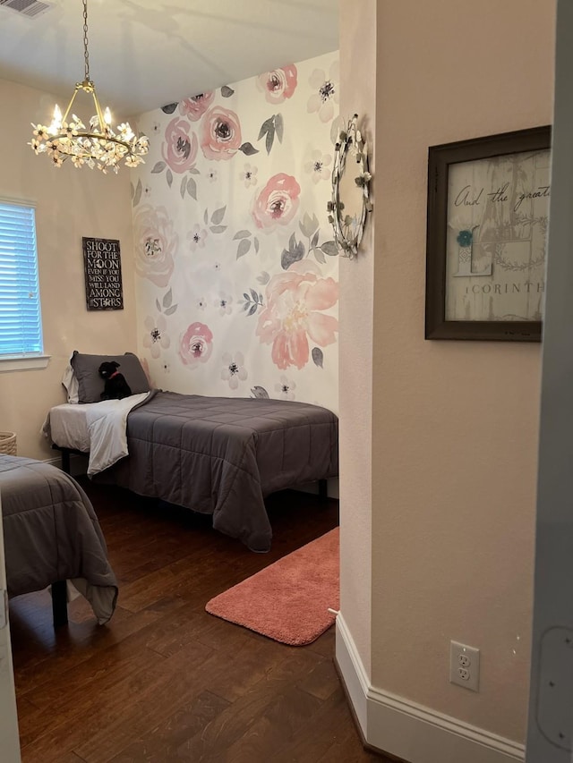 bedroom with baseboards and wood finished floors