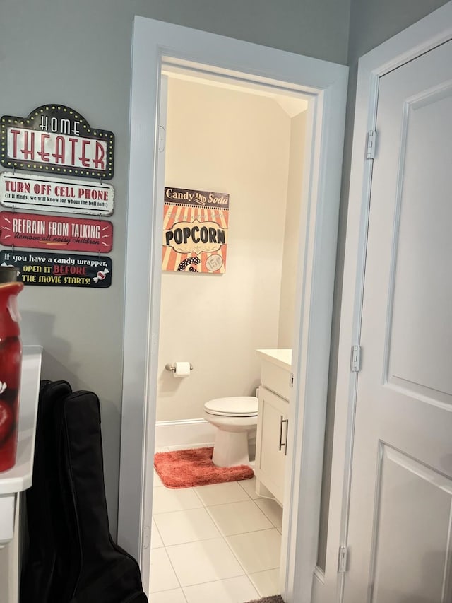 bathroom with toilet, tile patterned flooring, and baseboards