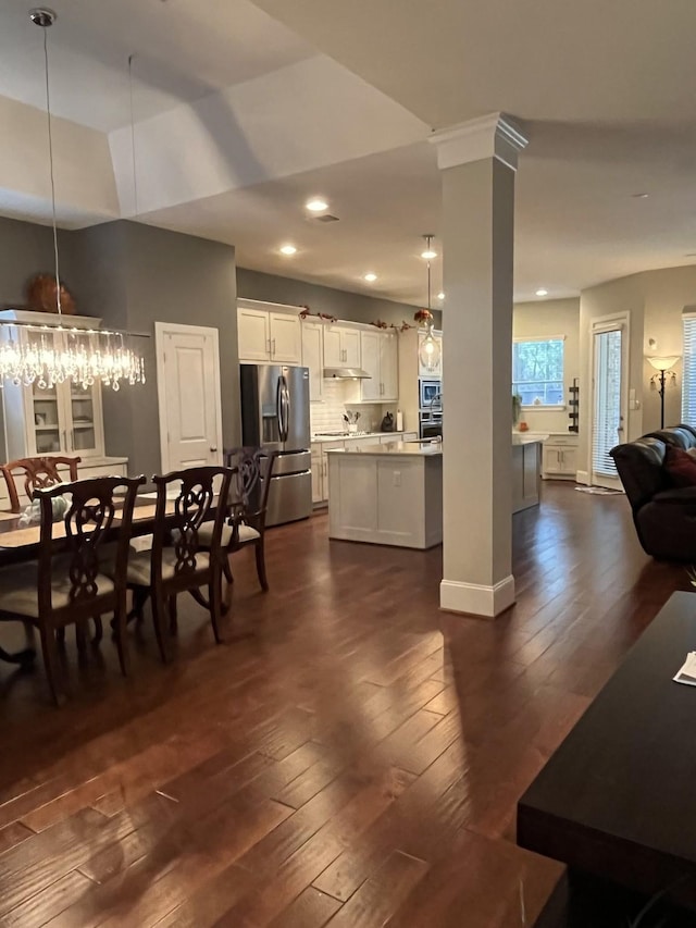 dining room featuring recessed lighting, ornate columns, an inviting chandelier, dark wood-type flooring, and baseboards